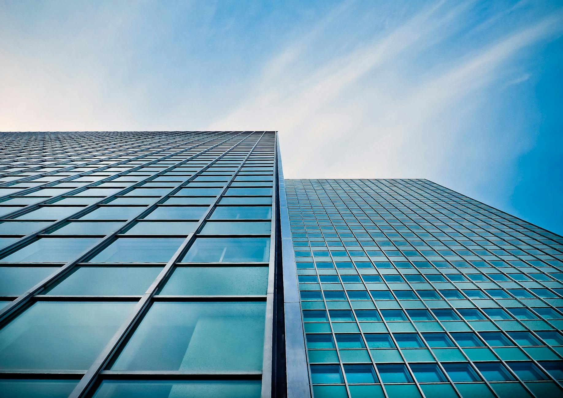 low angle view of office building against blue sky